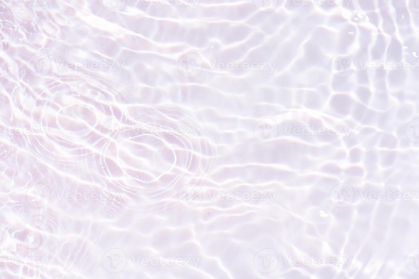 Bluewater waves on the surface ripples blurred. Defocus blurred transparent blue colored clear calm water surface texture with splash and bubbles. Water waves with shining pattern texture background. photo