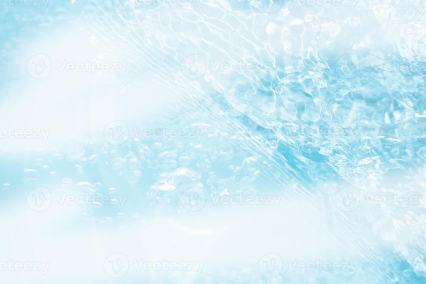Blue water with ripples on the surface. Defocus blurred transparent blue colored clear calm water surface texture with splashes and bubbles. Water waves with shining pattern texture background. photo