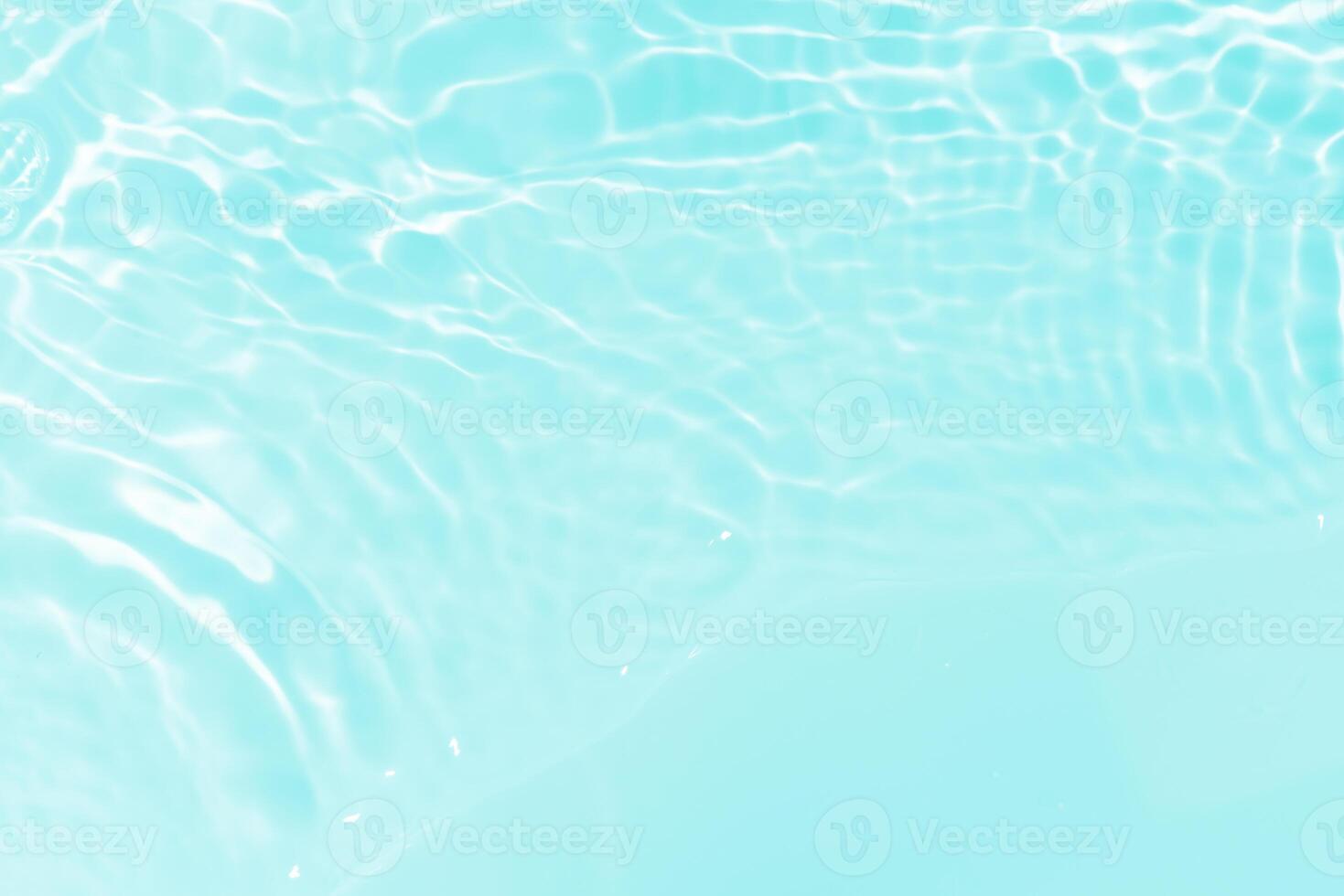 Blue water with ripples on the surface. Defocus blurred transparent blue colored clear calm water surface texture with splashes and bubbles. Water waves with shining pattern texture background. photo