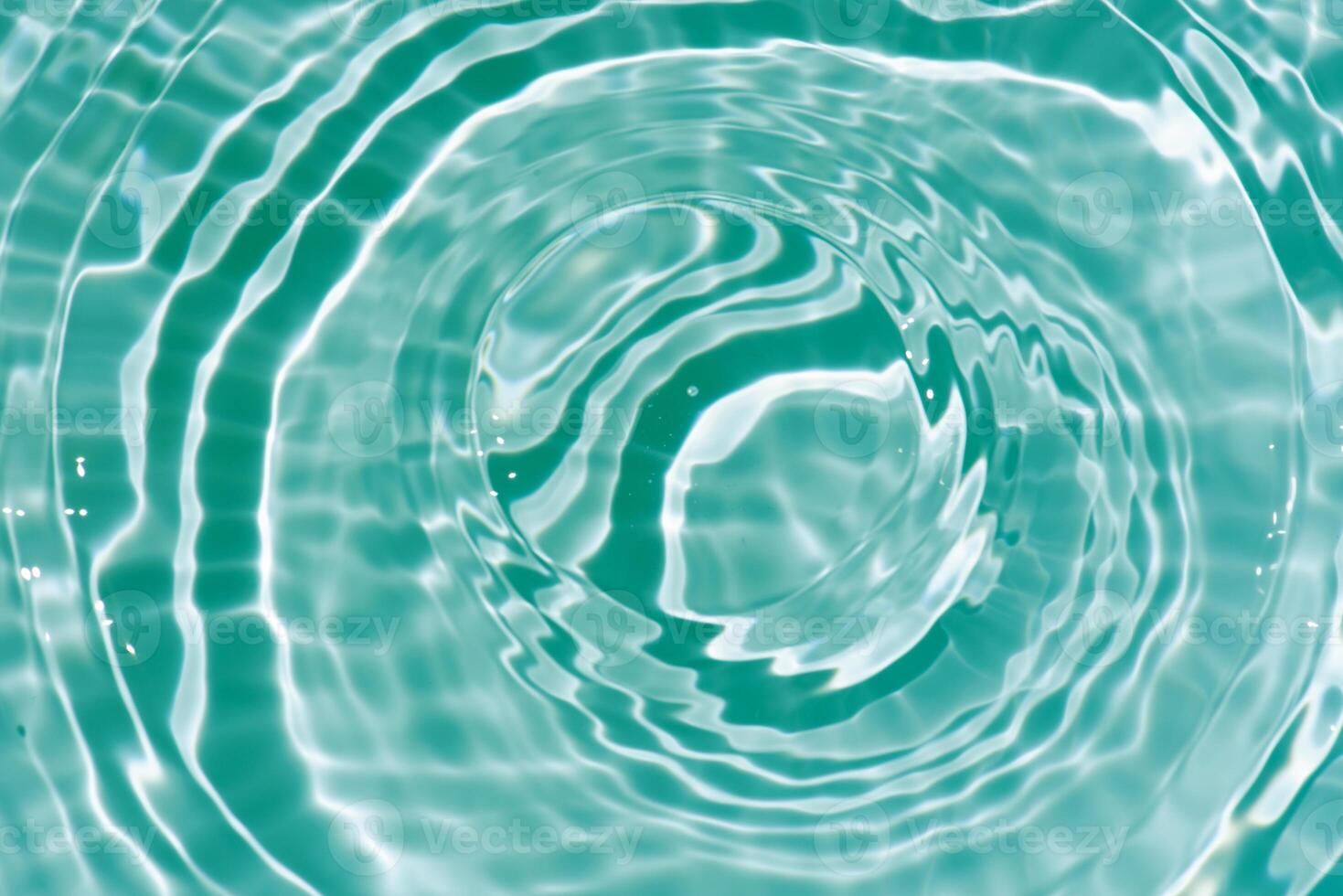 Bluewater waves on the surface ripples blurred. Defocus blurred transparent blue colored clear calm water surface texture with splash and bubbles. Water waves with shining pattern texture background. photo