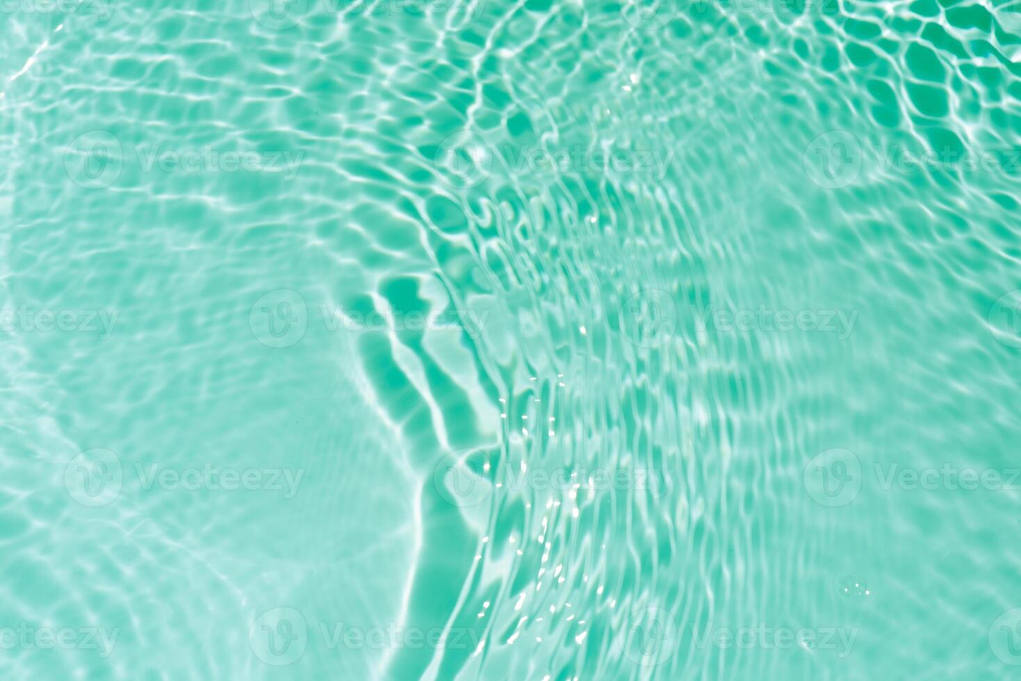 Bluewater waves on the surface ripples blurred. Defocus blurred transparent blue colored clear calm water surface texture with splash and bubbles. Water waves with shining pattern texture background. photo