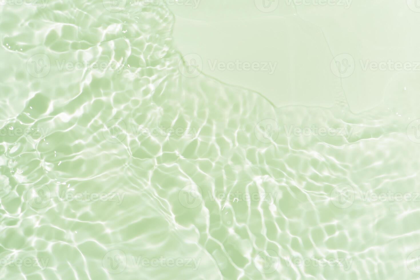 Bluewater waves on the surface ripples blurred. Defocus blurred transparent blue colored clear calm water surface texture with splash and bubbles. Water waves with shining pattern texture background. photo
