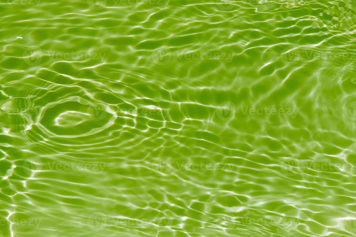 Bluewater waves on the surface ripples blurred. Defocus blurred transparent blue colored clear calm water surface texture with splash and bubbles. Water waves with shining pattern texture background. photo