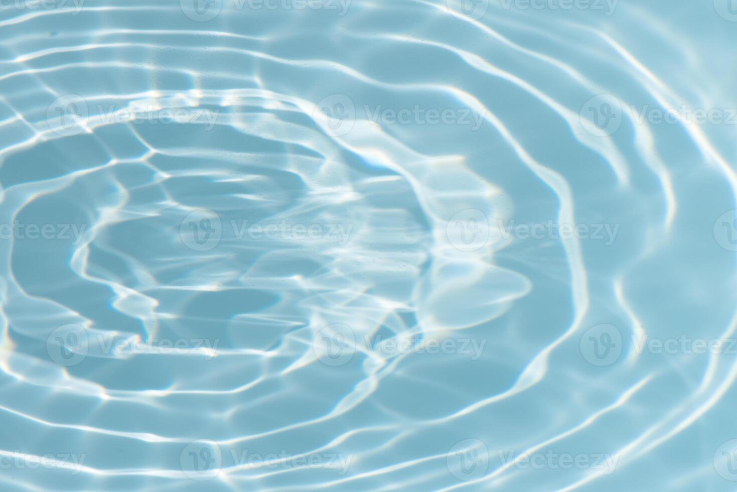 Bluewater waves on the surface ripples blurred. Defocus blurred transparent blue colored clear calm water surface texture with splash and bubbles. Water waves with shining pattern texture background. photo