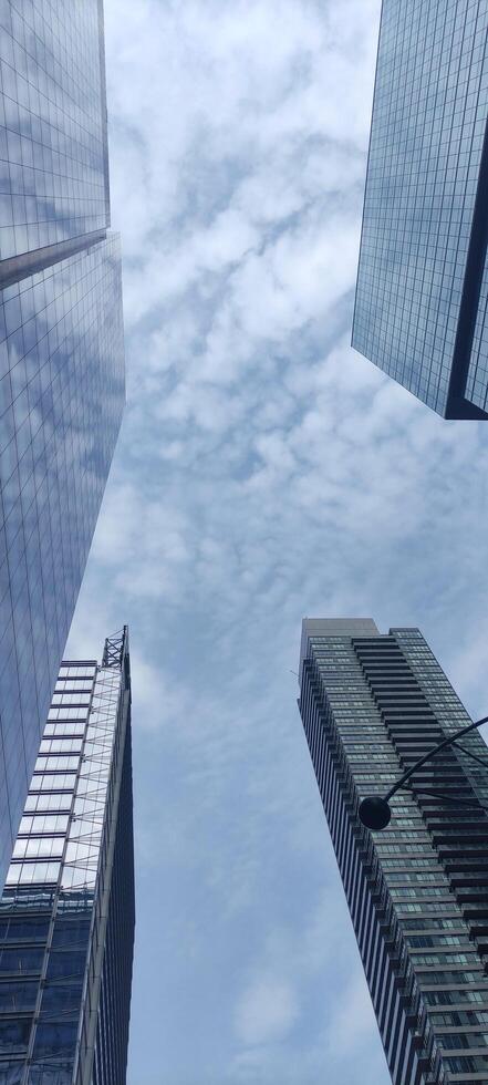 Skyscrapers view from below on the background of the sky, megalopolis buildings photo