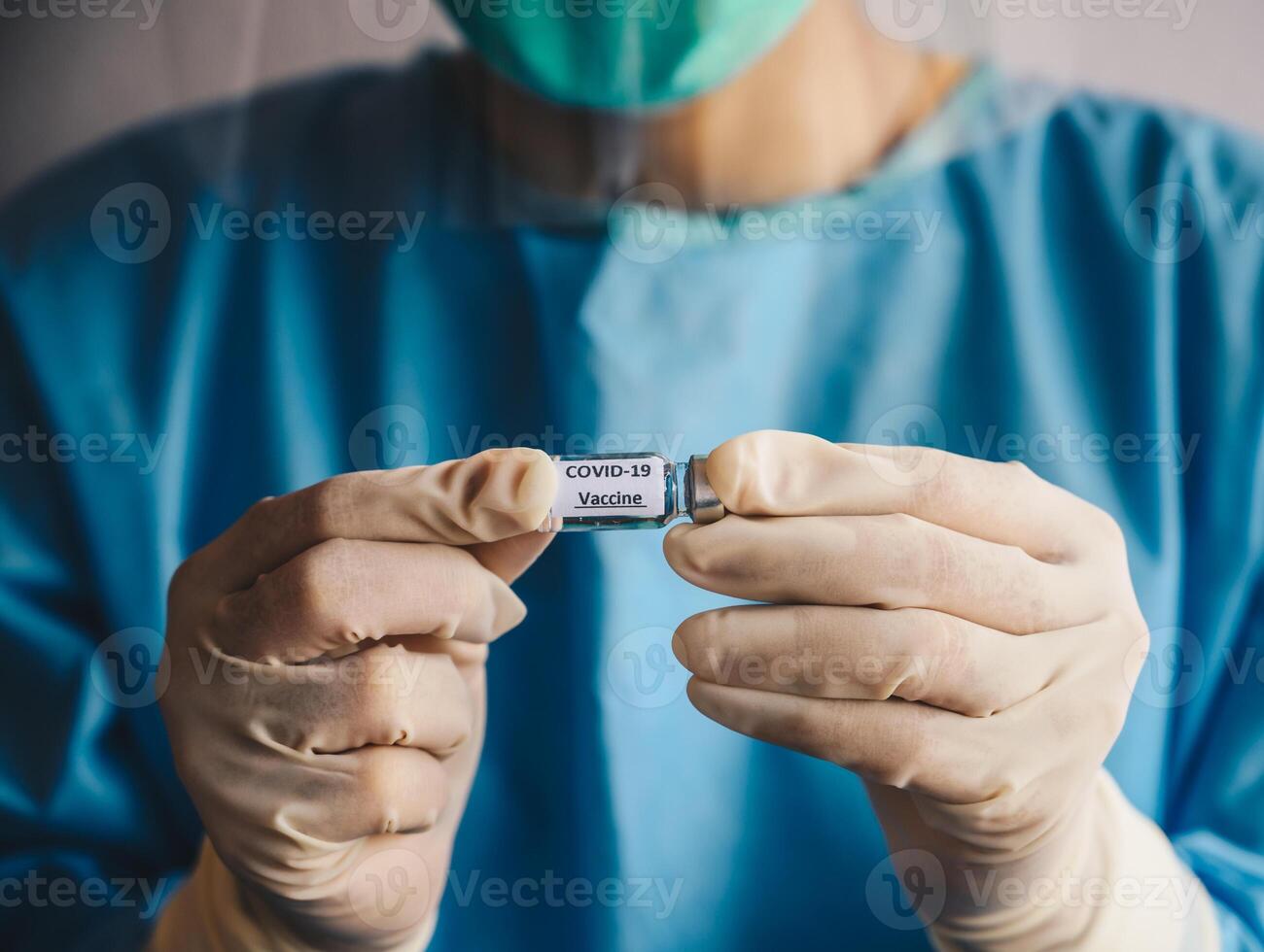 Close up of scientist doctor hand holding a sample test bottle of Covid-19 vaccine. photo