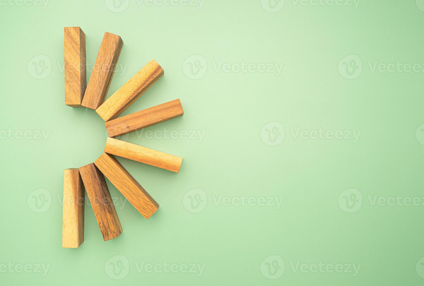 Top view of empty eight wooden blocks isolated on a green background photo