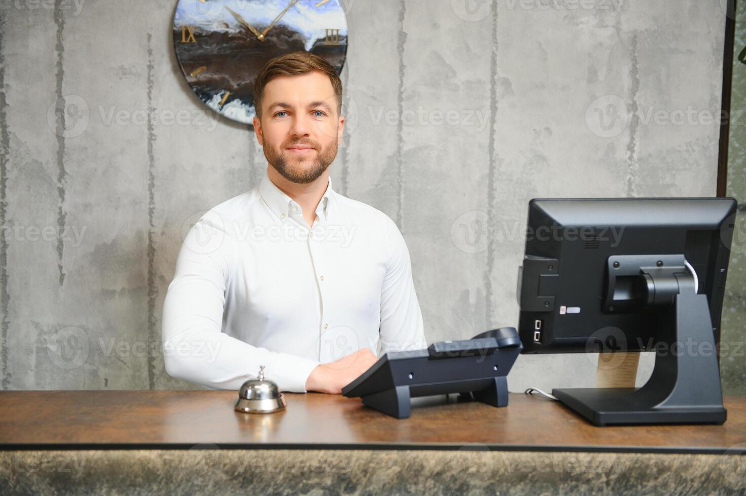 Portrait of receptionist at desk in lobby photo