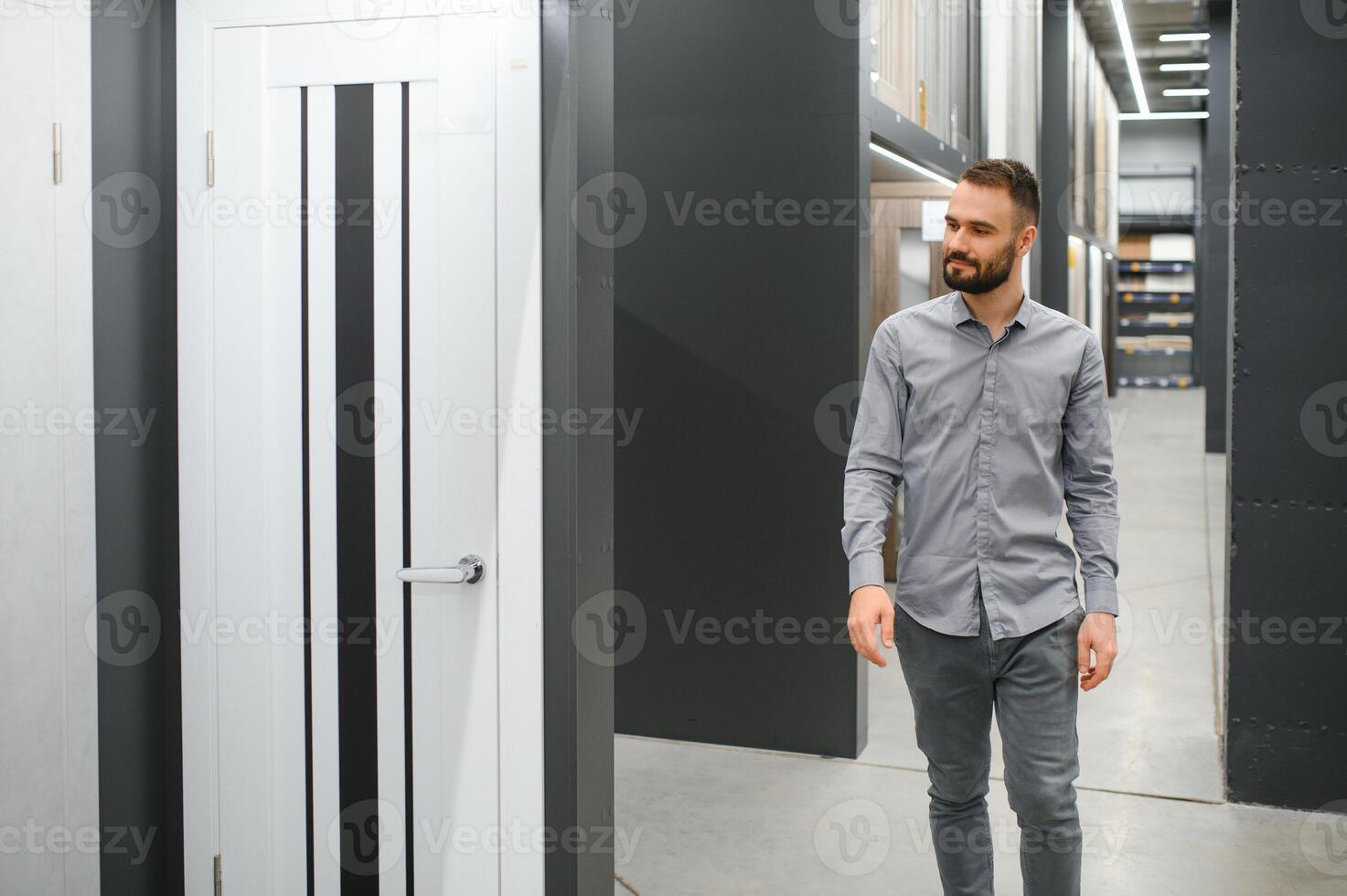 A man chooses a door for the house. Buying a door at a hardware store photo