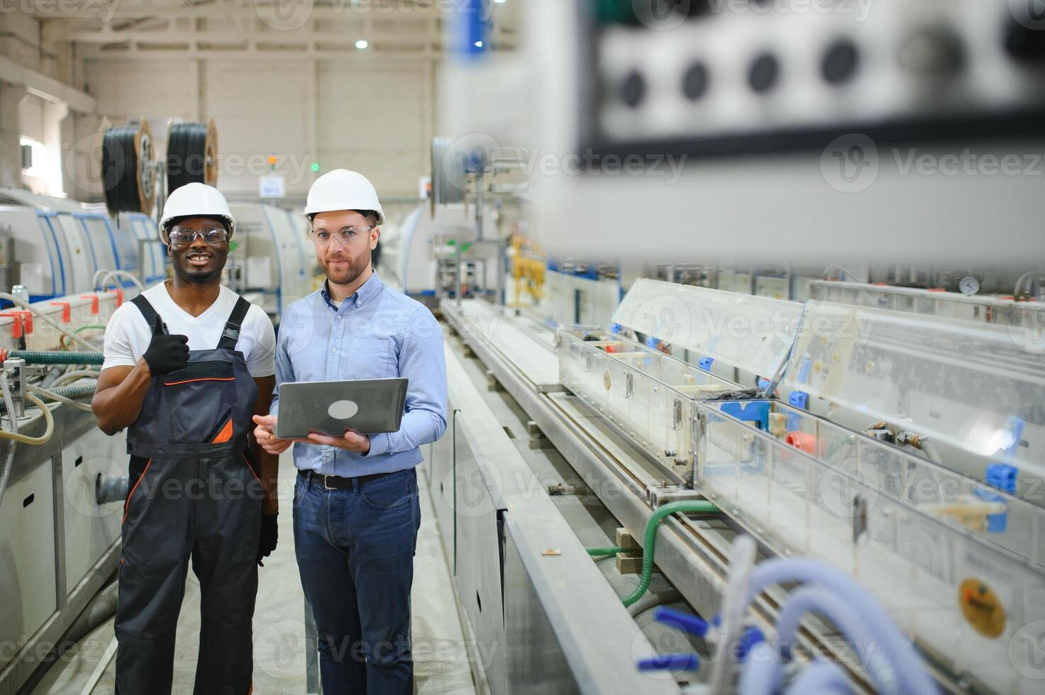 Two Heavy Industry Engineers Stand in Factory photo