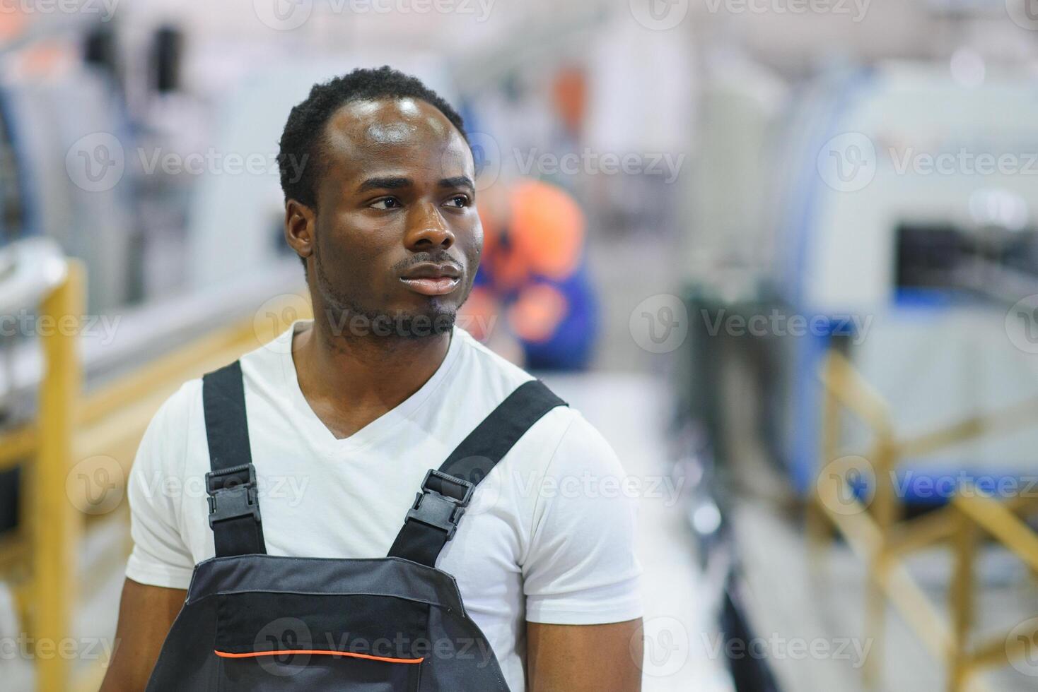 An African-American male worker in a plastic window frame factory photo