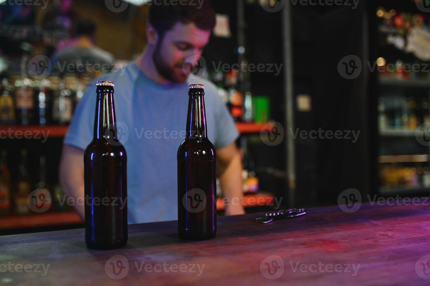 Portrait Of Smiling Male Bar Owner Standing Behind Counter photo