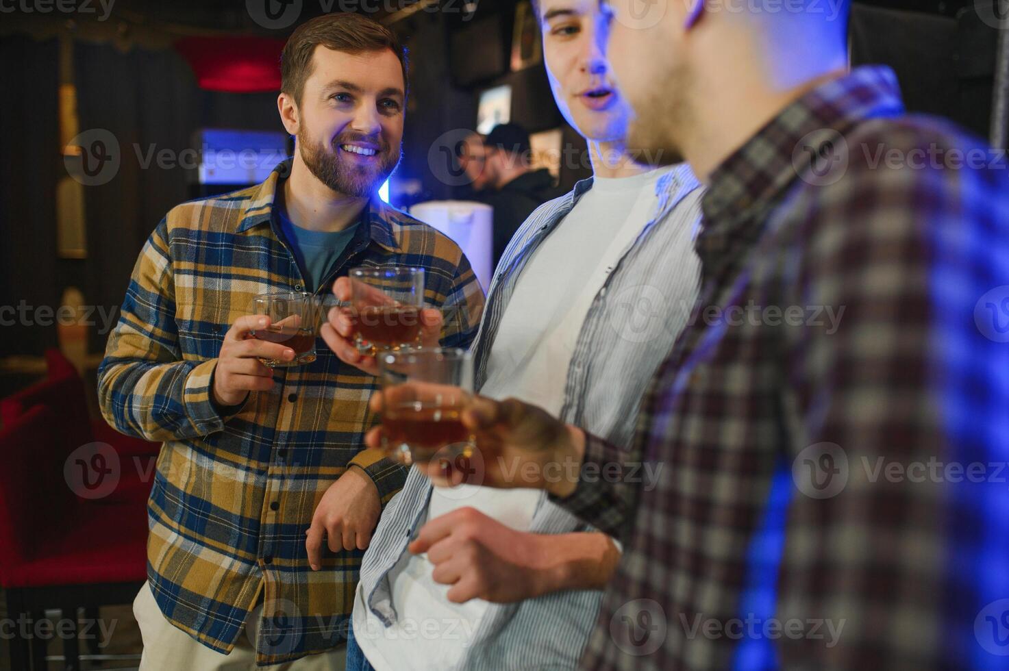 Conception of nightlife. People have fun in the club. With alcohol in hands. photo