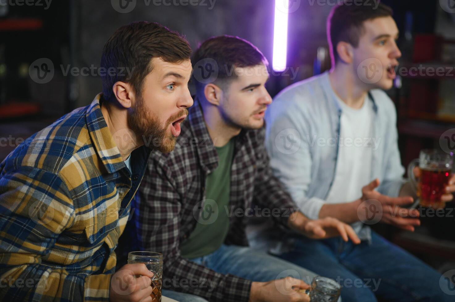 Sport, people, leisure, friendship, entertainment concept - happy male football fans or good yuong friends drinking beer, celebrating victory at bar or pub. Human positive emotions concept photo