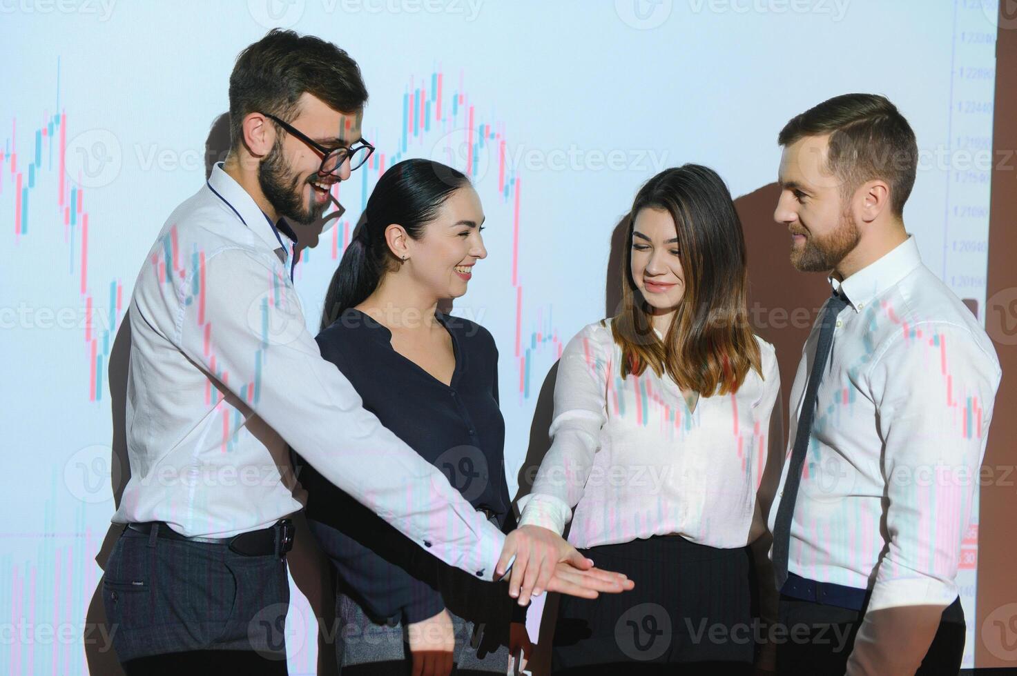 Group of business people working at modern office.Technical price graph, red and blue candlestick chart and stock trading computer screen background. Double exposure. Traders analyzing data photo