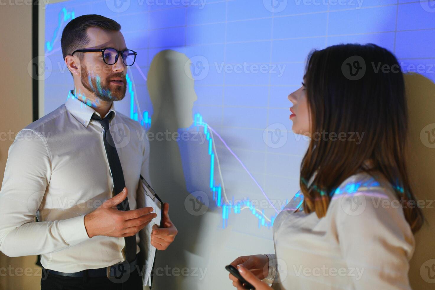 Group of business people working. Technical price graph and indicator, red and blue candlestick chart and stock trading computer screen background. Traders analyzing data photo