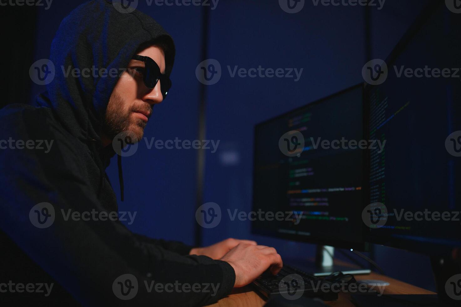 Wanted hackers coding virus ransomware using laptops and computers. Cyber attack, system breaking and malware concept photo