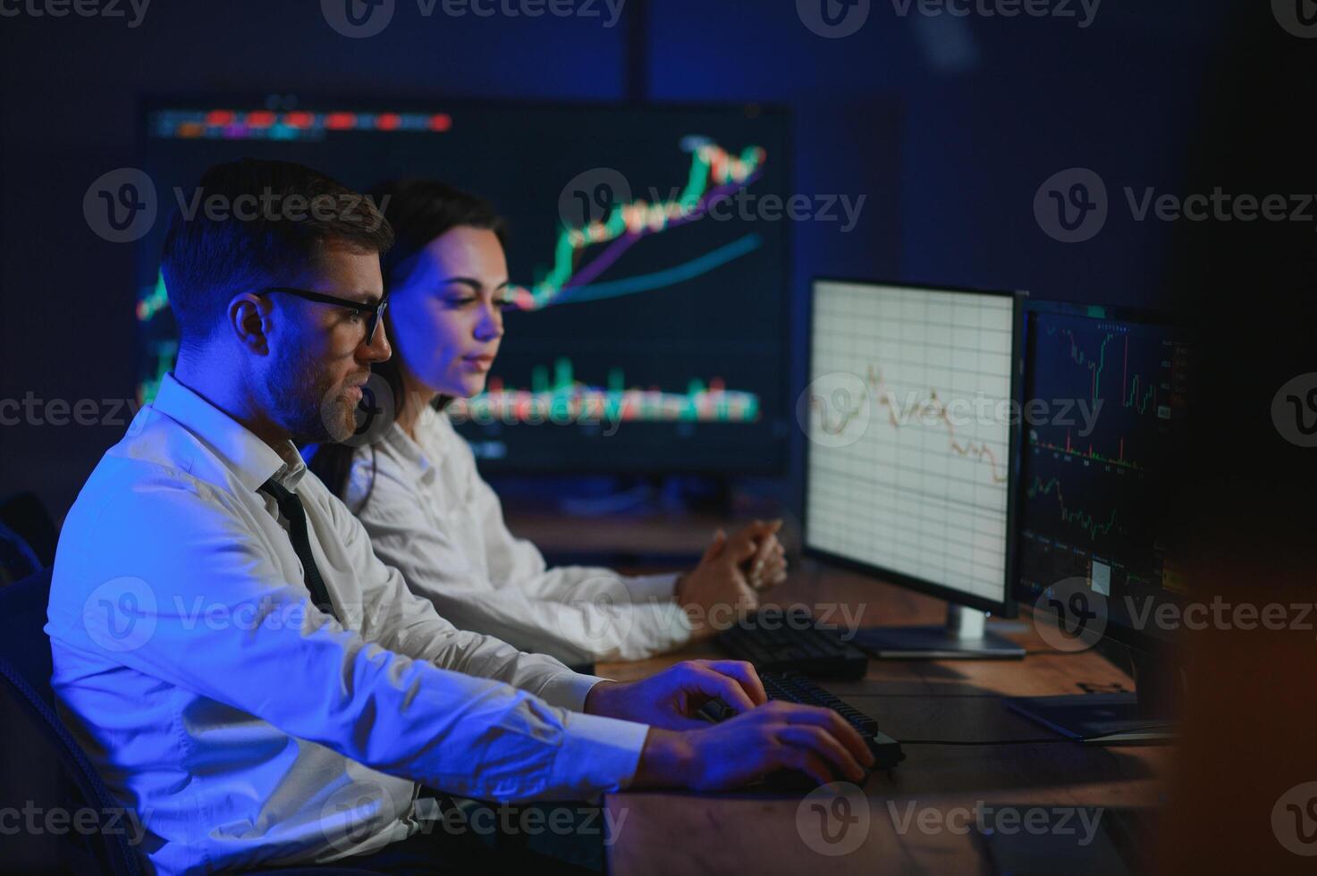 Team of traders working at monitor computer and browsing online in trading office photo