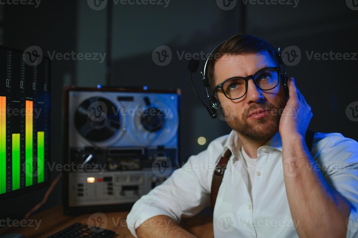 Secret agent listens on the reel tape recorder. Officer wiretapping in headphones. Spying of conversations. Intelligence gathering. Espionage concept photo