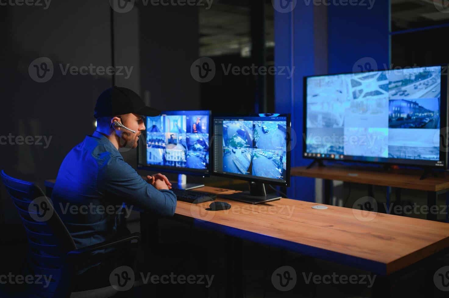 Security operator controls CCTV cameras in office at night. Modern security system and social safety concept photo