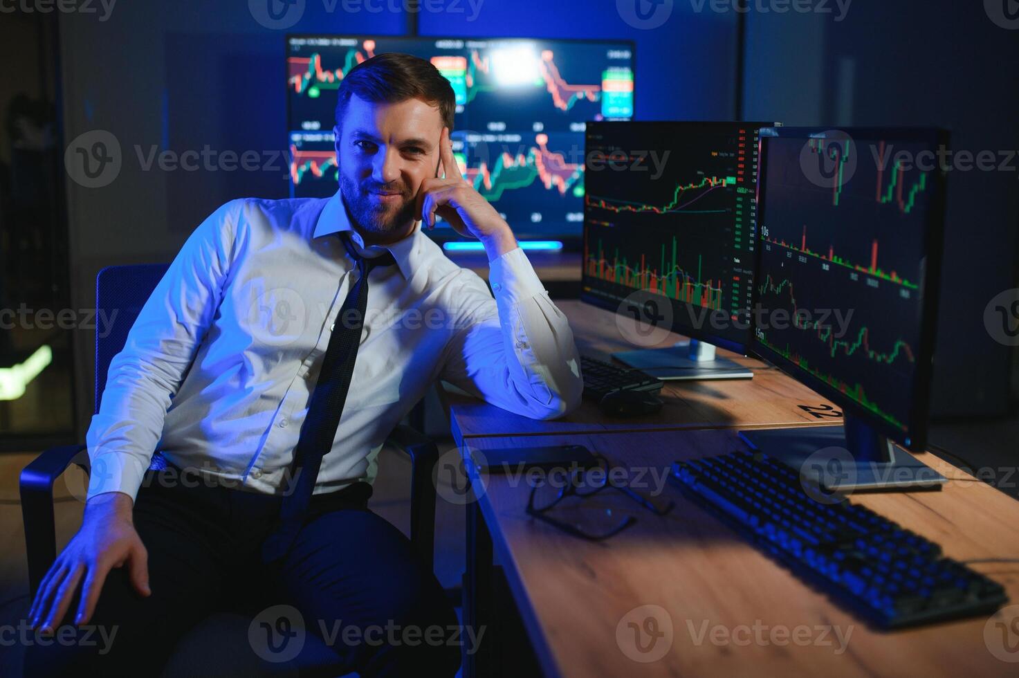 businessman comparing stock market data late in the evening photo