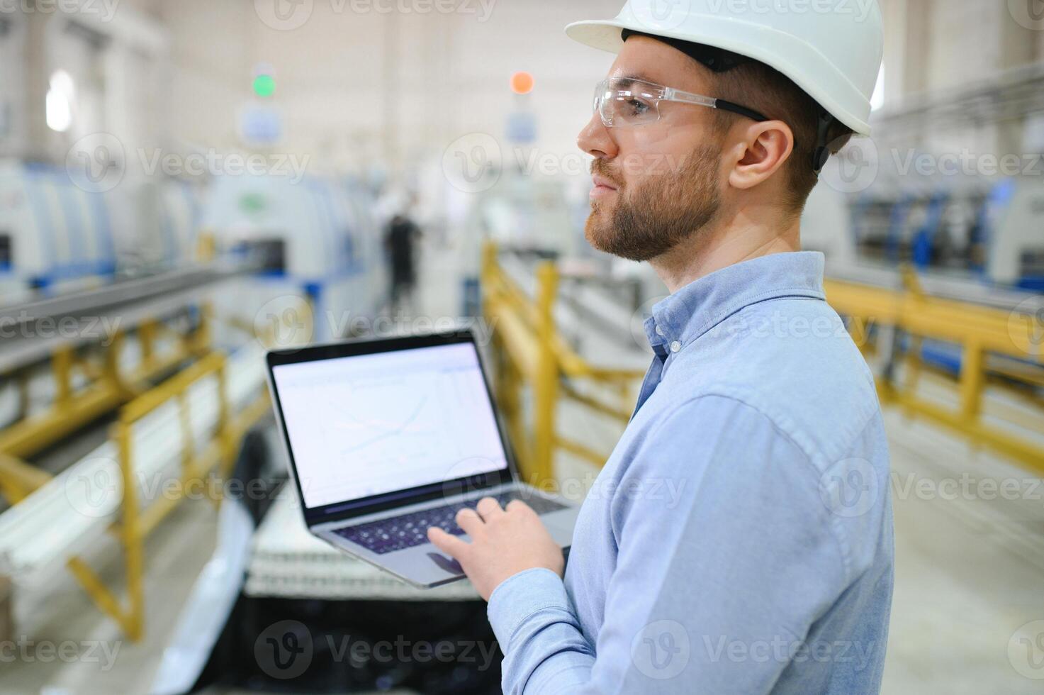 Portrait of confident handsome technical engineer in hardhat. photo