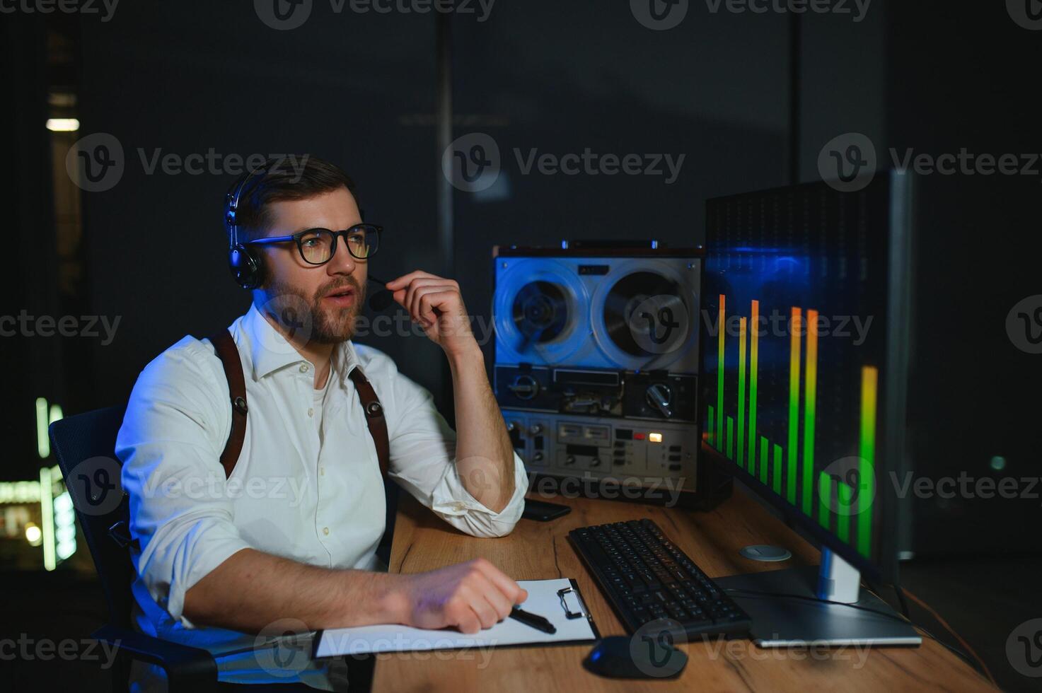 Secret agent listens on the reel tape recorder. Officer wiretapping in headphones photo
