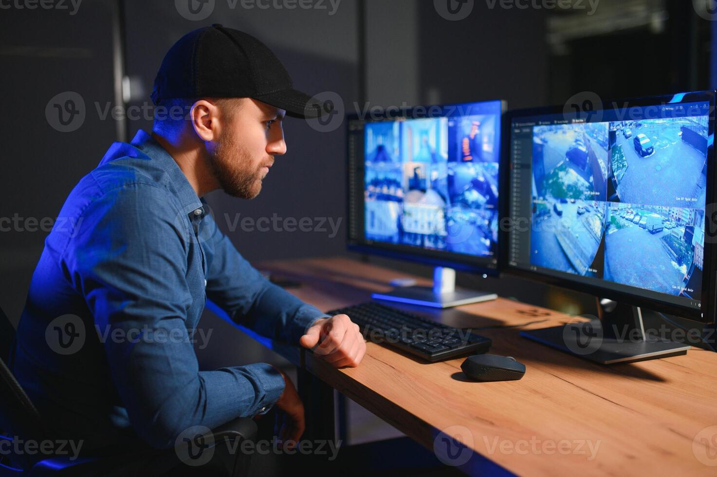 Security operator controls CCTV cameras in office at night. Modern security system and social safety concept photo