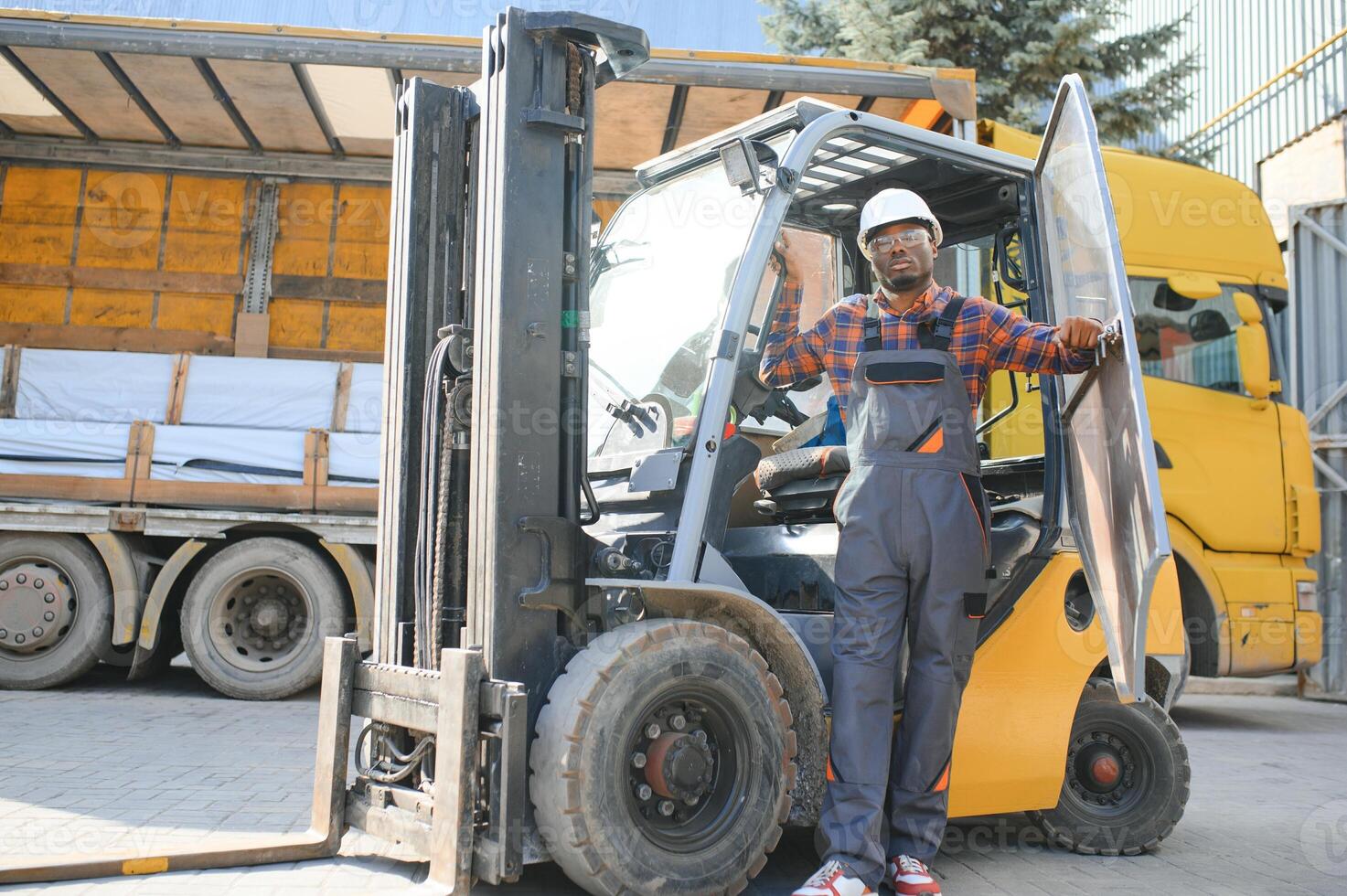 African American Man at work. Professional operation engineering. Young worker forklift driver photo