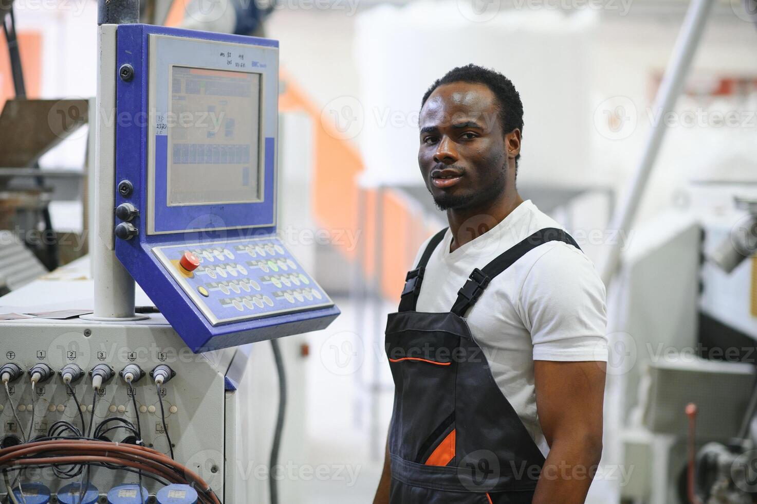Portrait of industrial engineer. factory worker standing in factory production line photo