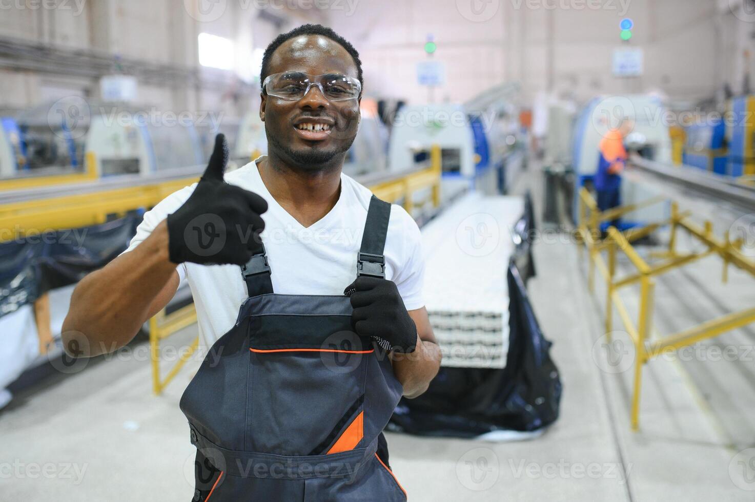 Factory for aluminum and PVC windows and doors production. Manual worker assembling PVC windows and doors photo