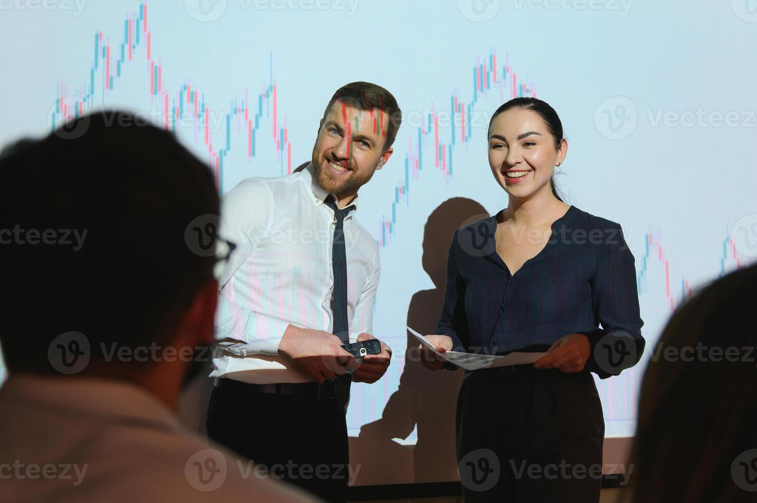 Group of business people working at modern office.Technical price graph, red and blue candlestick chart and stock trading computer screen background. Double exposure. Traders analyzing data photo