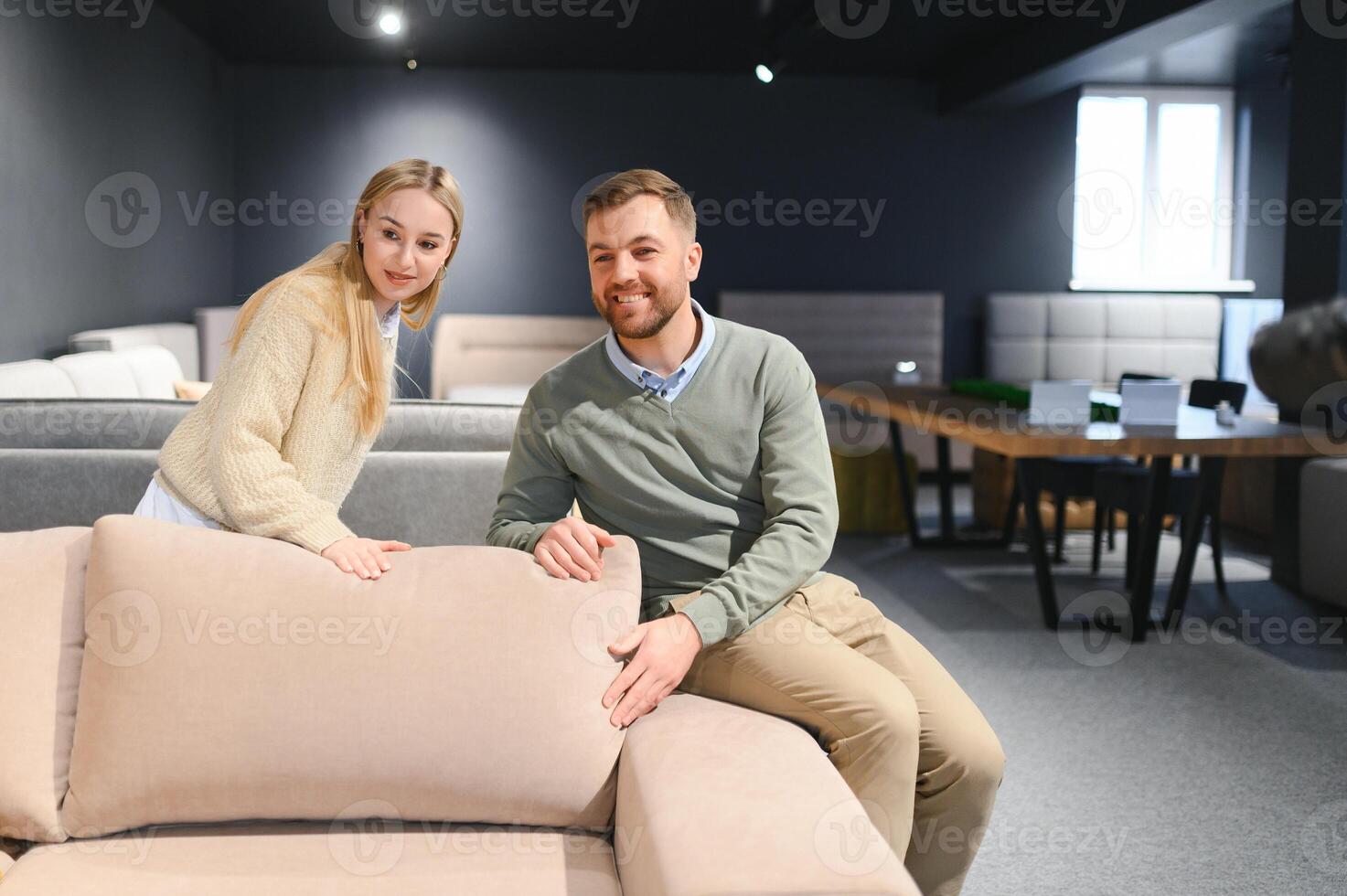 Couple choosing sofa and pillows at furniture store photo