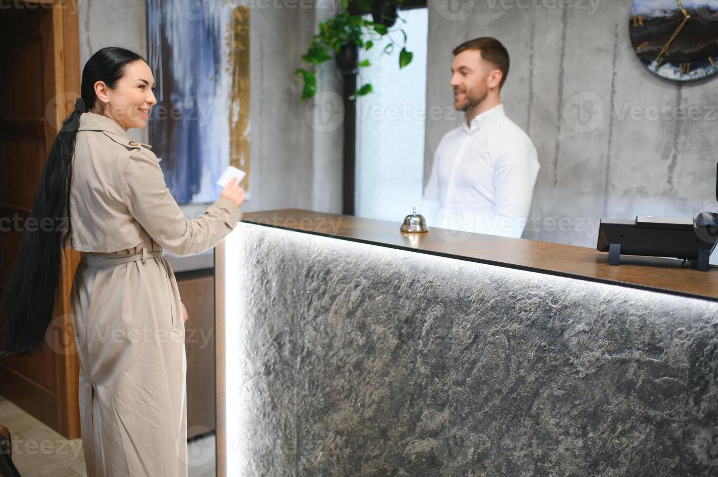Close up of hand guest takes room key at check-in desk of the hotel. Hotel concept photo