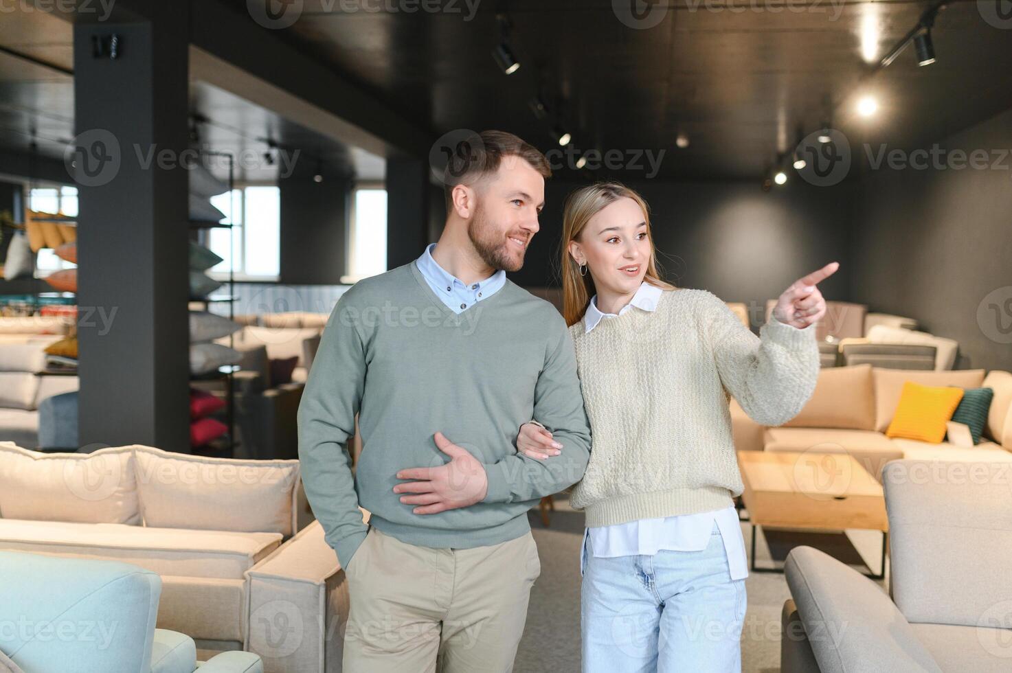 Couple choosing sofa in furniture store photo