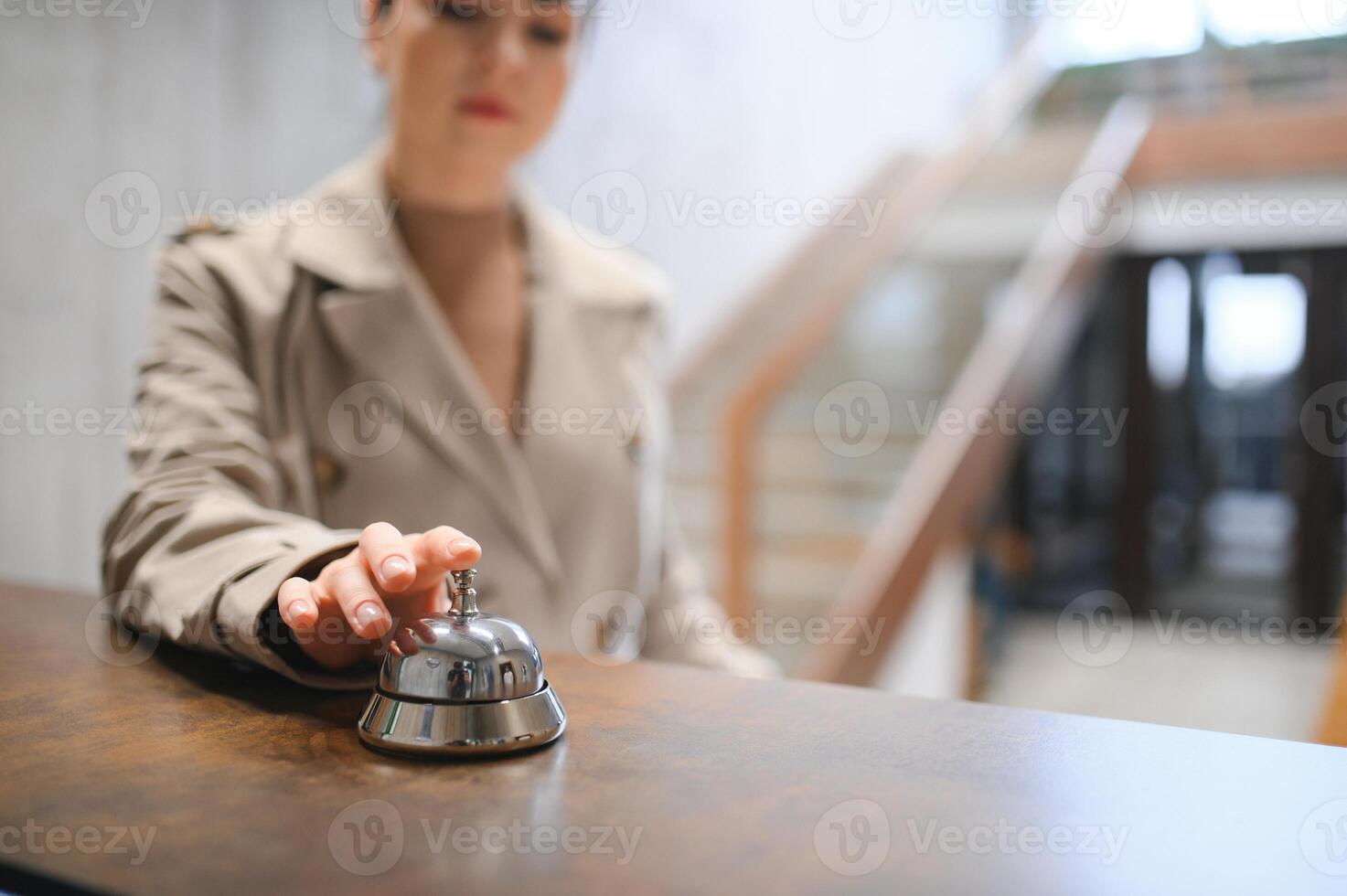 Businesswoman with luggage in modern hotel lobby photo
