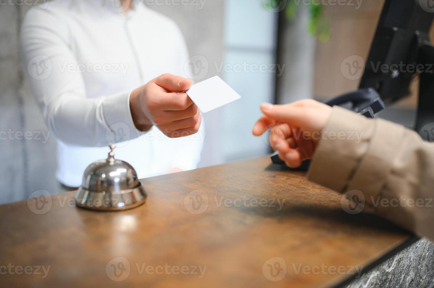 Close up of hand guest takes room key at check-in desk of the hotel. Hotel concept photo