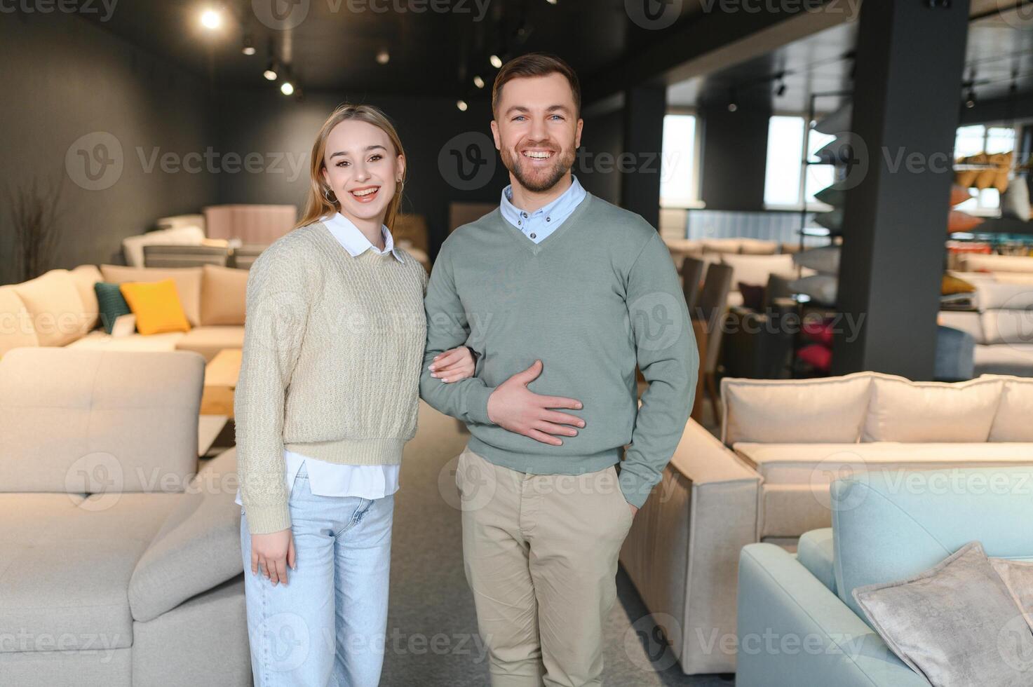 Couple choosing sofa and pillows at furniture store photo