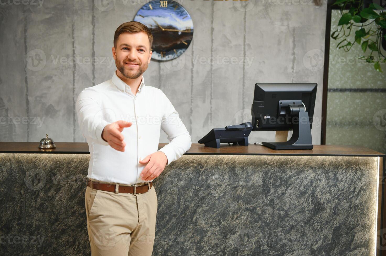 Portrait of receptionist at desk in lobby, hotel photo