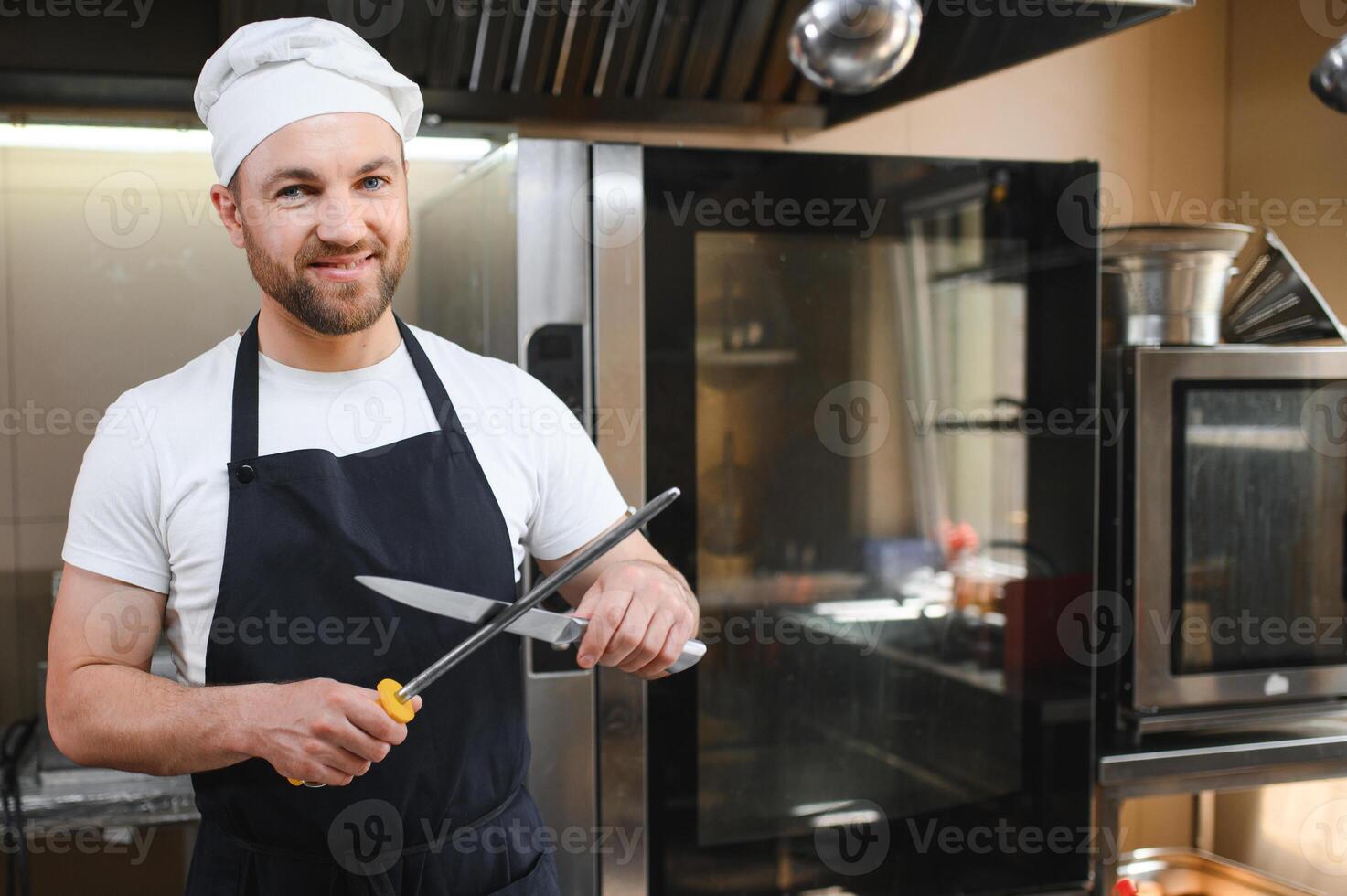 Chef cook in uniform cooking in the big cooker at the restaurant kitchen photo