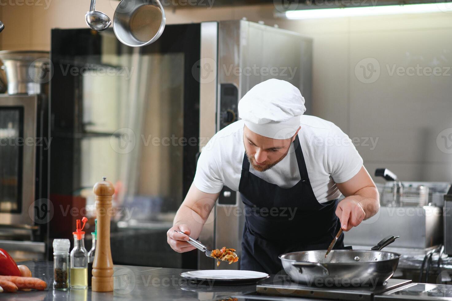 Chef cook preparing vegetables in his kitchen photo
