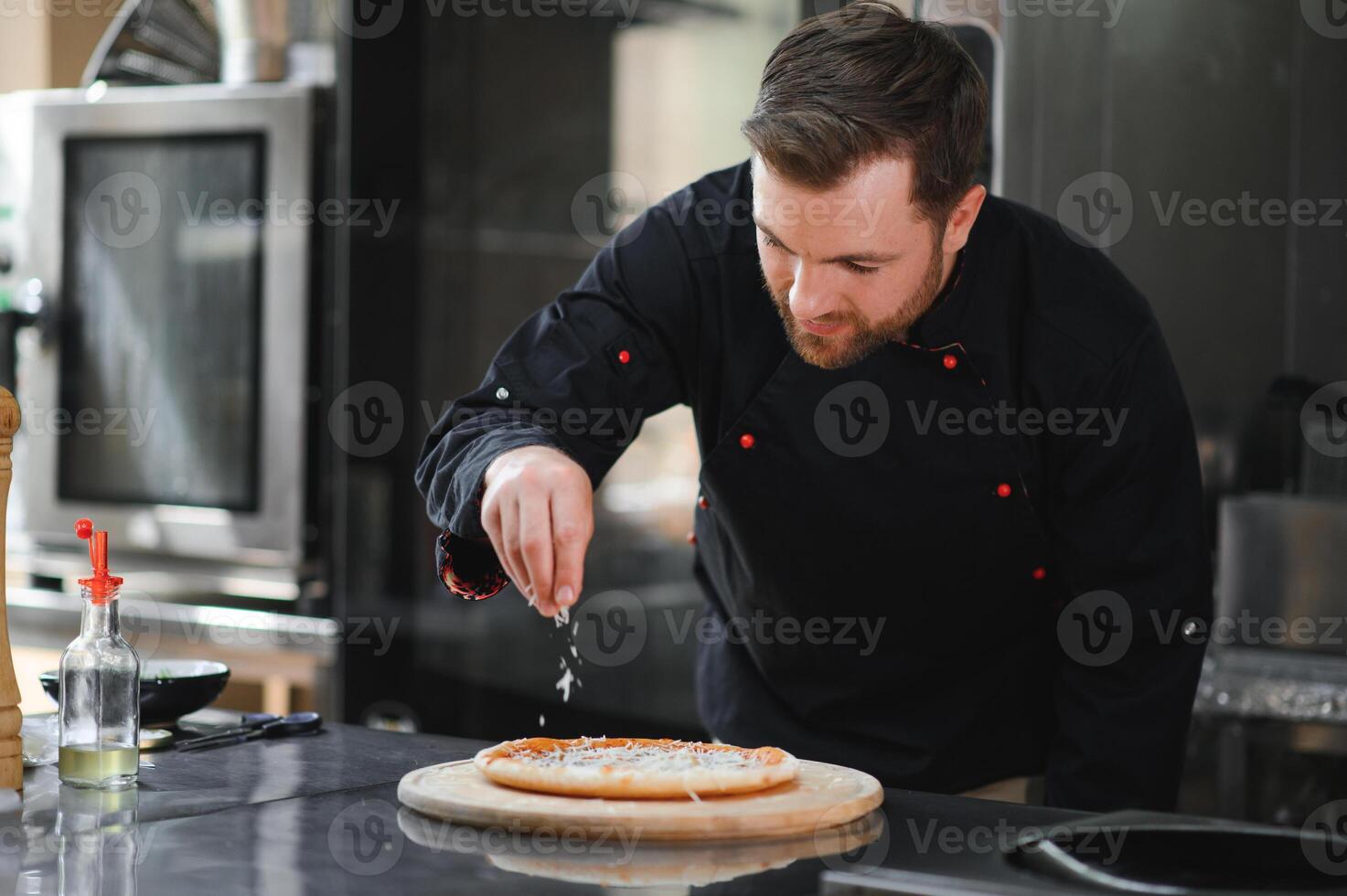 chef baker in uniform making pizza at kitchen photo