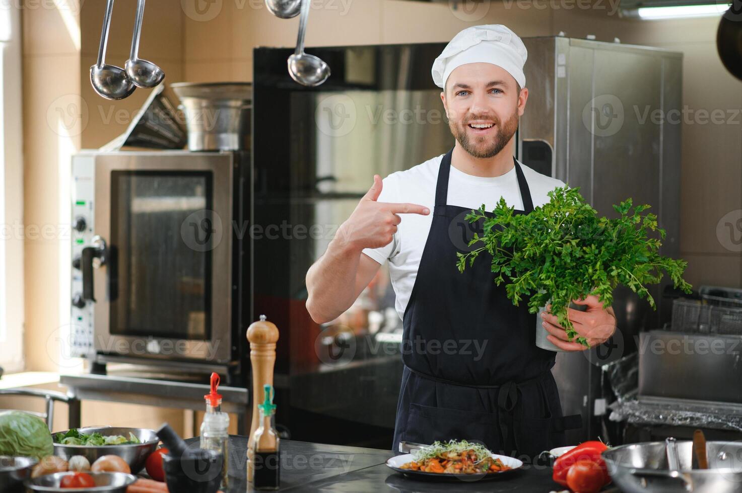 Chef cook in uniform cooking in the big cooker at the restaurant kitchen photo