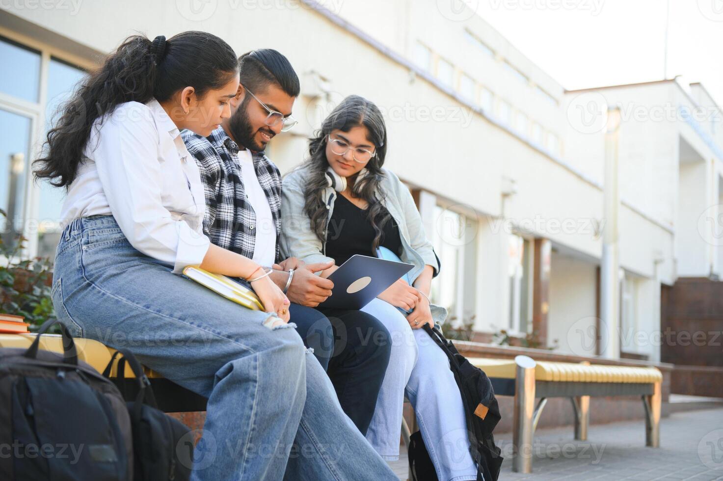 group of young students checking exam results or waiting for project approval on laptop at collage campus photo