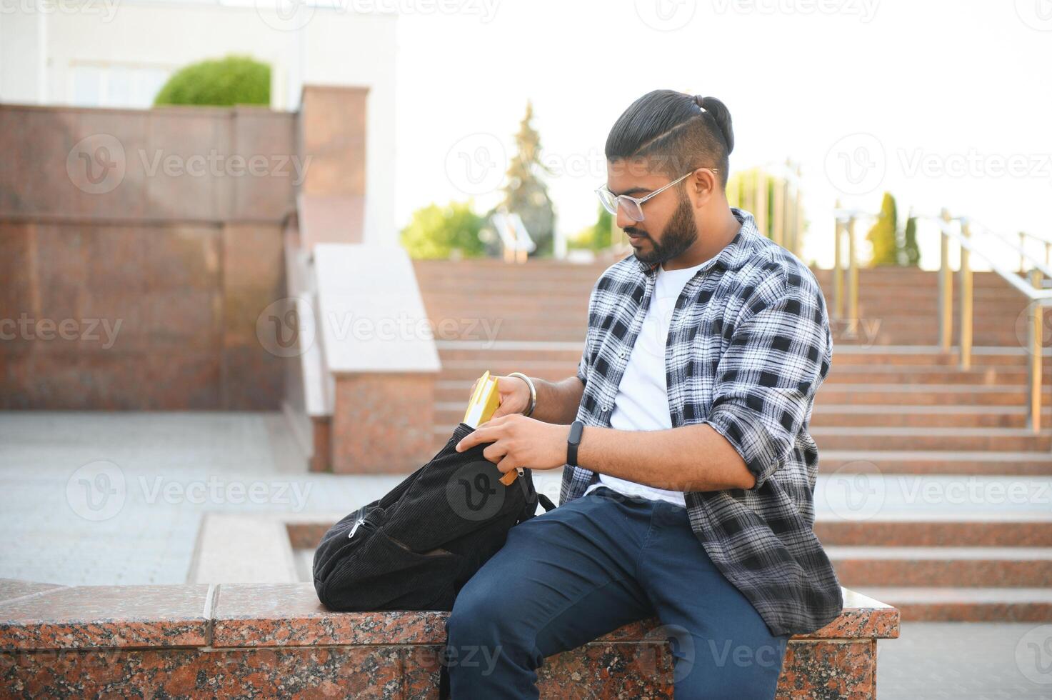 Happy indian male student at the university photo