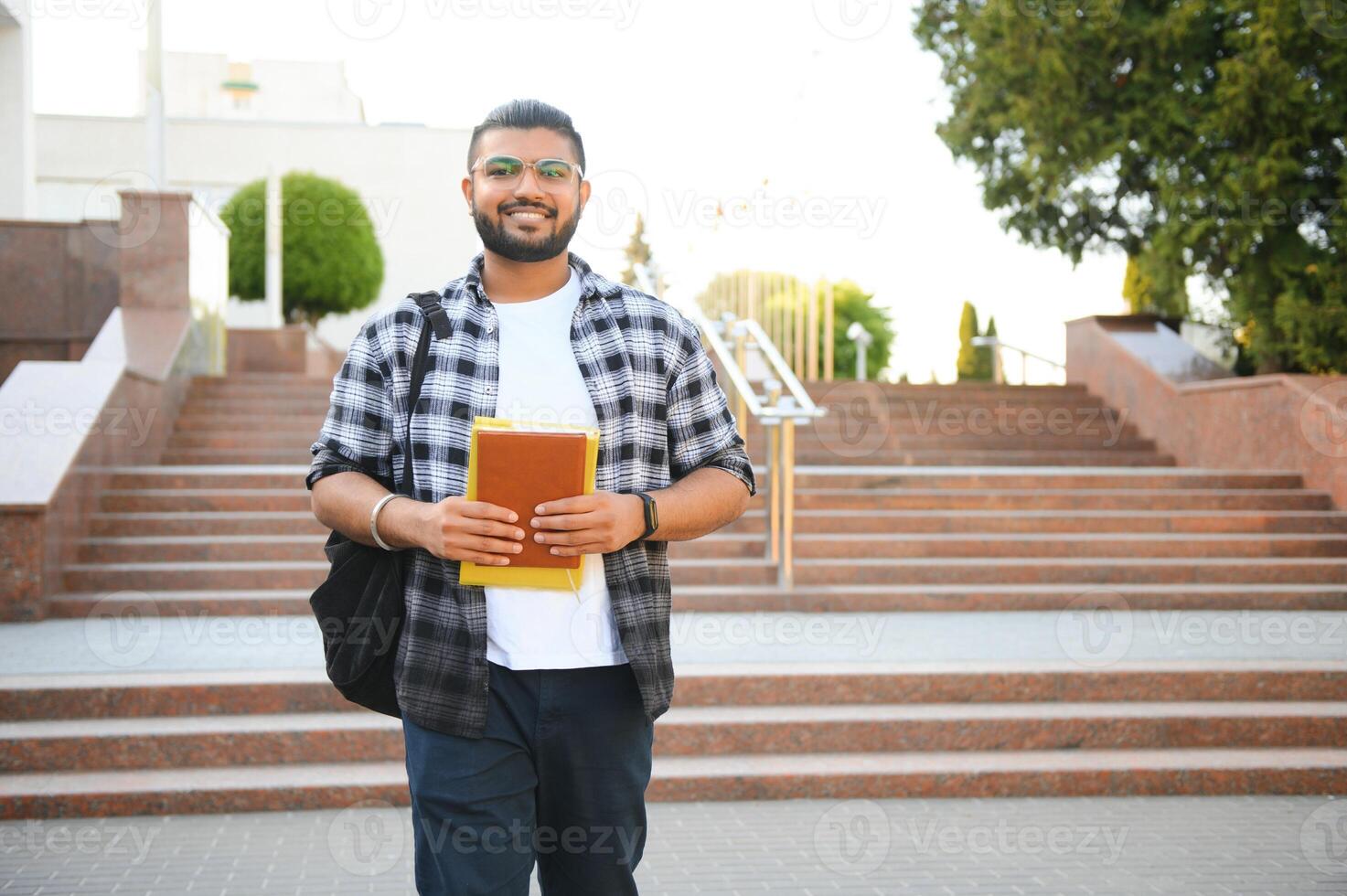 Happy indian male student at the university photo