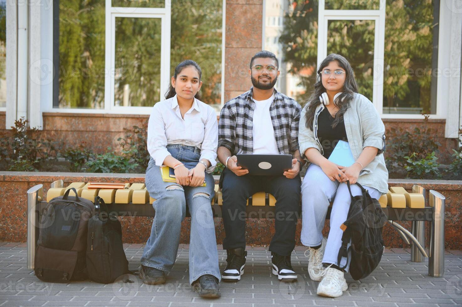 group of young students checking exam results or waiting for project approval on laptop at collage campus photo