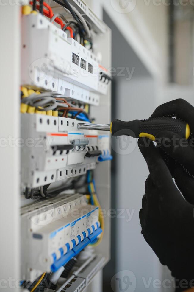 Close-up of electrician working on circuitry photo