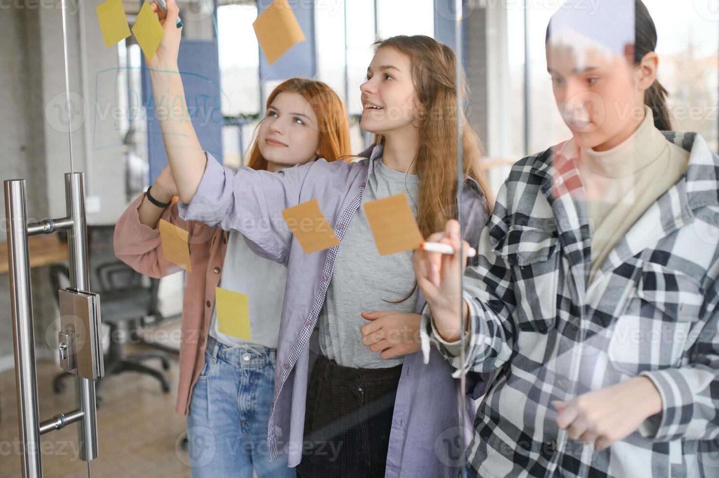 students discuss university assignments together photo