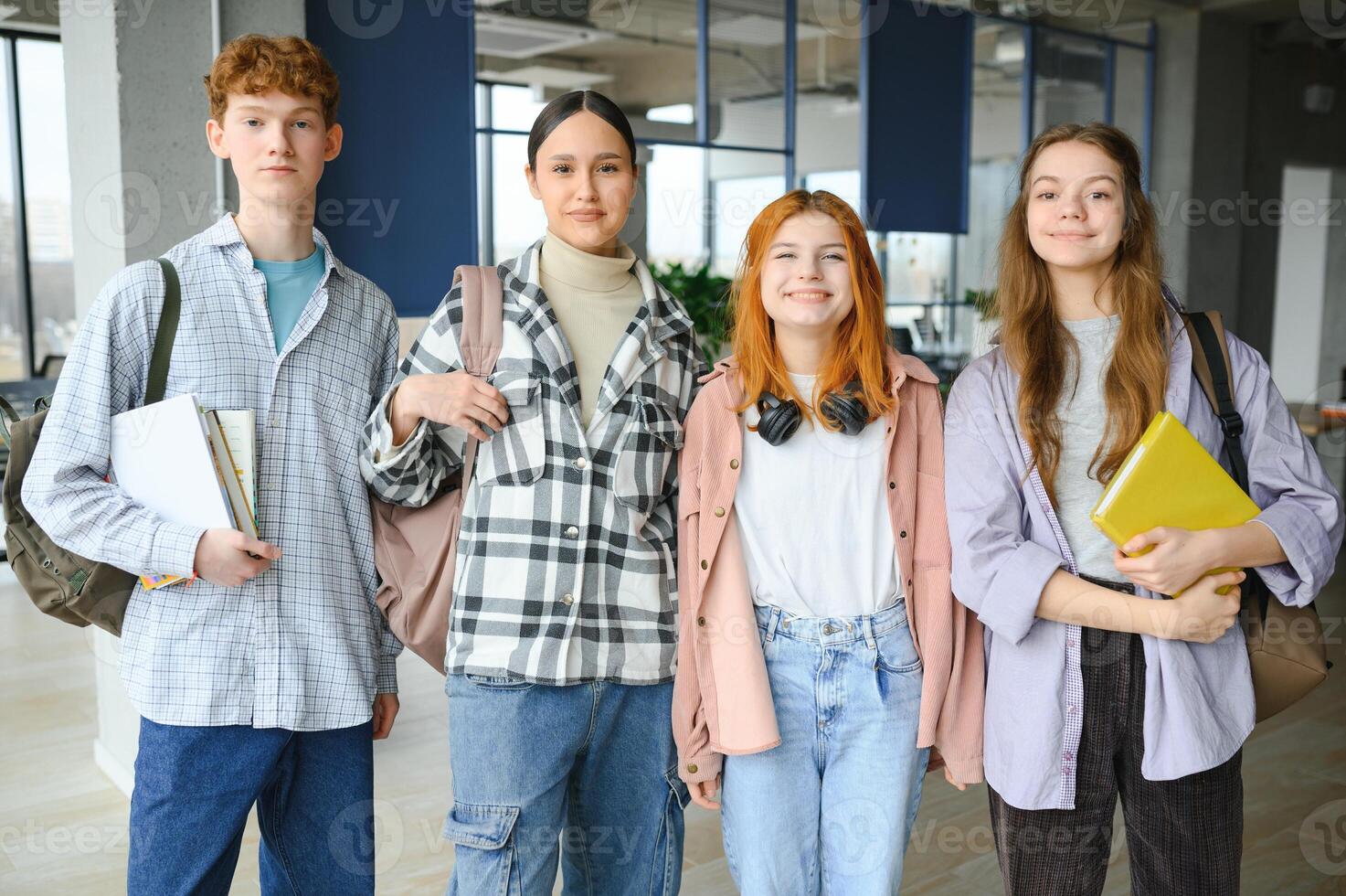 Happy diverse college students posing for group portrait, looking at camera, smiling photo